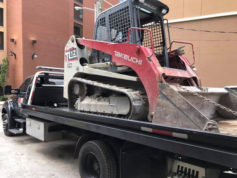 All Out Towing Light Equipment Towing Nashville Skid Steer on Flatbed Tow Truck