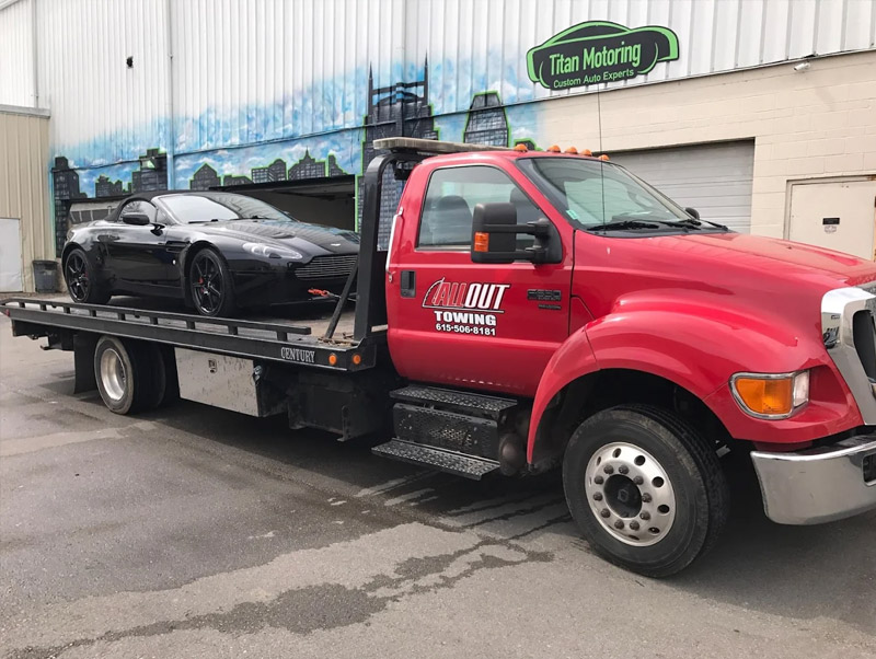 All Out Towing Long Distance Towing Nashville Car loaded on red flatbed tow truck