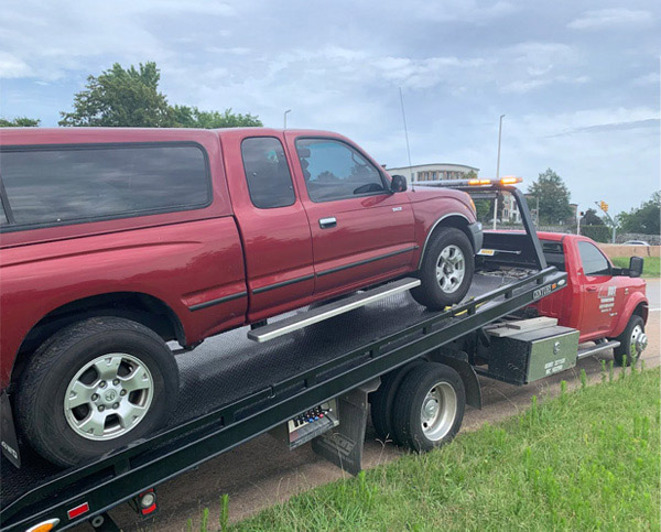 Pickup Truck Being loaded onto All Out Towing flatbed tow truck in Nashville